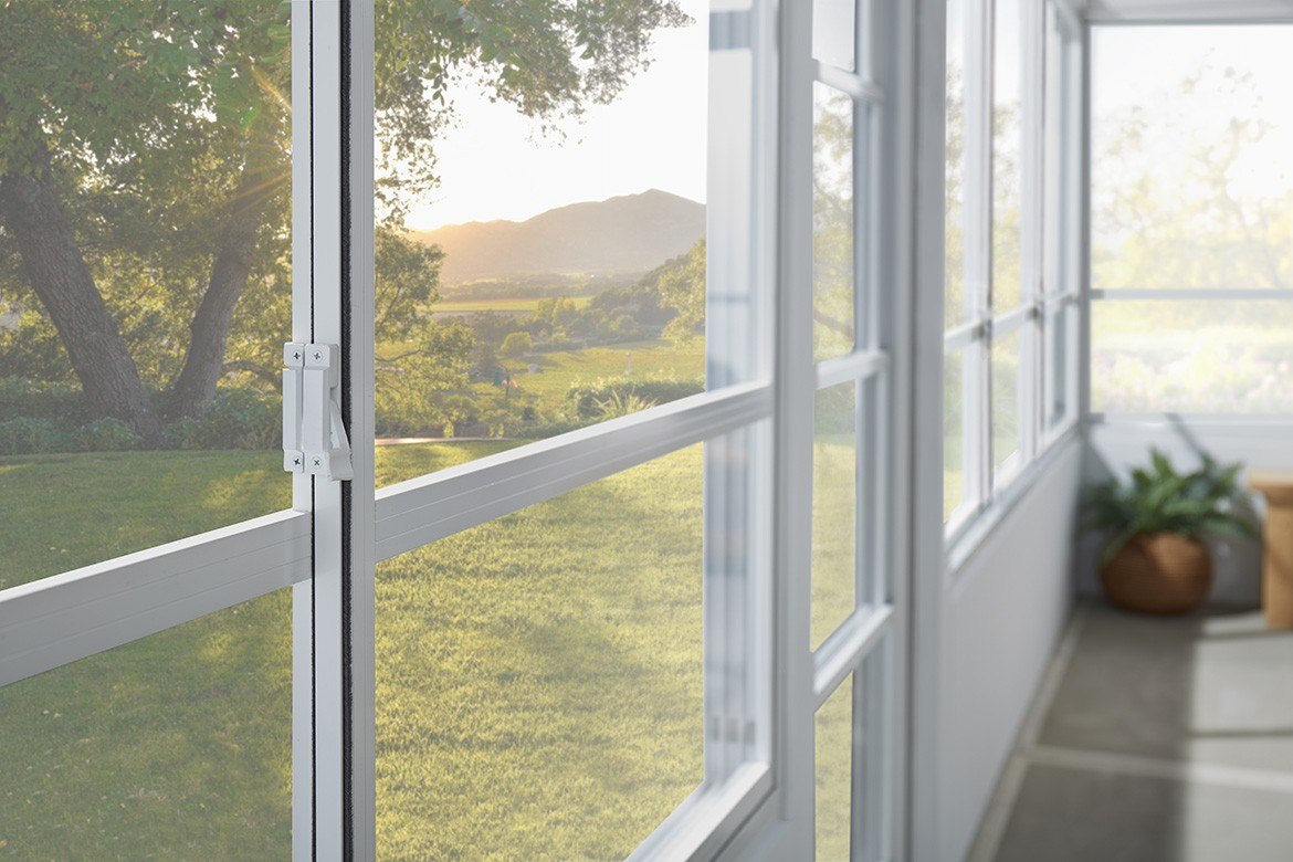 Screen door with a view of a garden and mountains